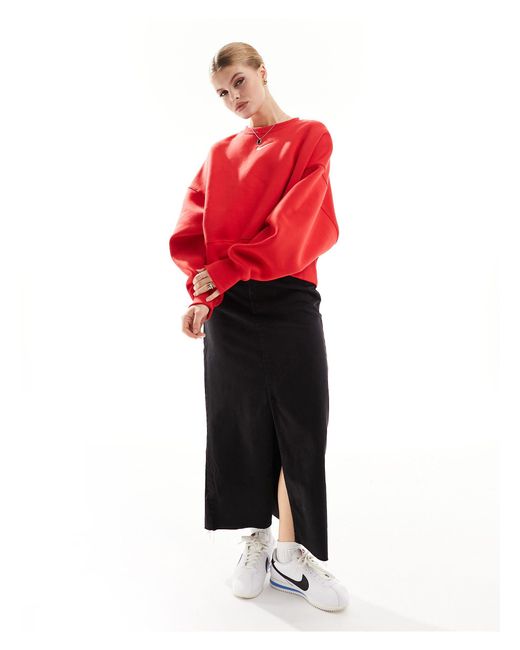 Sweat court unisexe coupe extra oversize en polaire à mini logo virgule Nike en coloris Red