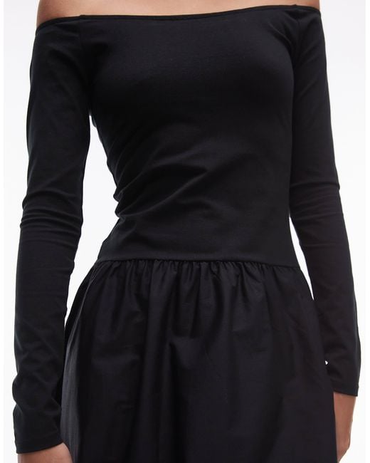 Robe mi-longue avec taille basse et encolure bardot Mango en coloris Black