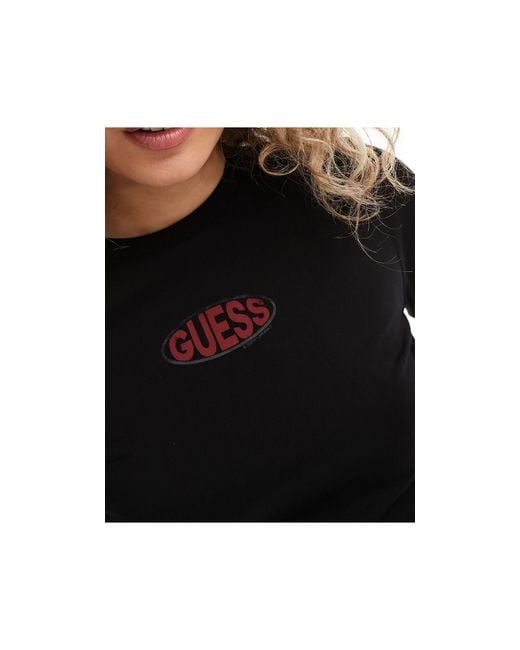 T-shirt a maniche lunghe nera con logo ovale di Guess in Black