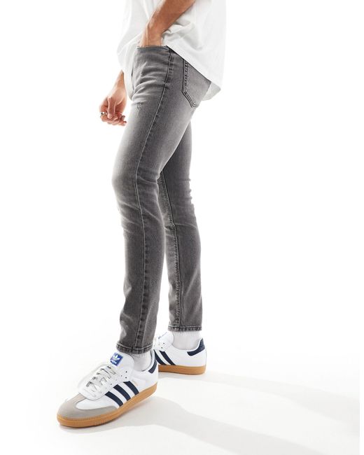 Jeans effetto spray super elasticizzati con strappi e pannelli nero slavato di ASOS in White da Uomo