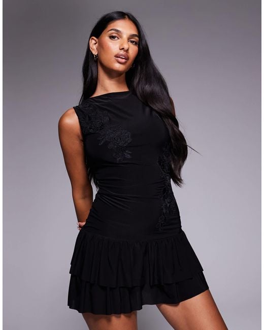 Fashionkilla Black Double-sculpted Slinky Slash Neck Low Back Ruffle Hem Flower Applique Mini Dress