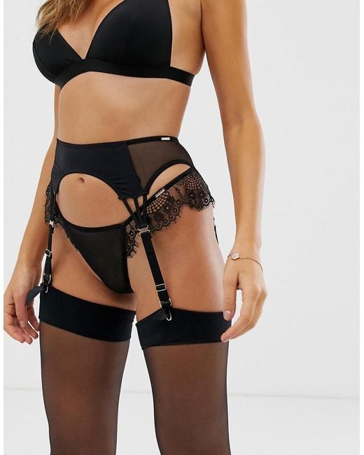 Bow garter belt with bone lace inserts elastic clip back.