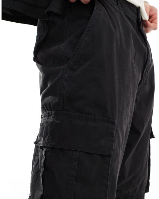 Pantaloni cargo multitasche neri a fondo ampio di Pull&Bear in Black da Uomo