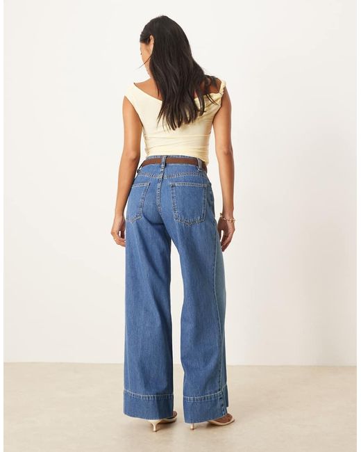 Vaqueros De Pernera Ancha Con Lavado Medio Oscuro, Cinturón Y Detalle De Raya En La Parte Delantera De Asos Design Petite-Azul ASOS de color Blue