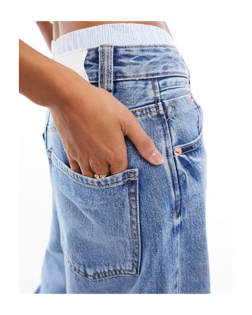 Petite - jeans a fondo ampio medio con vita stile boxer di Stradivarius in Blue