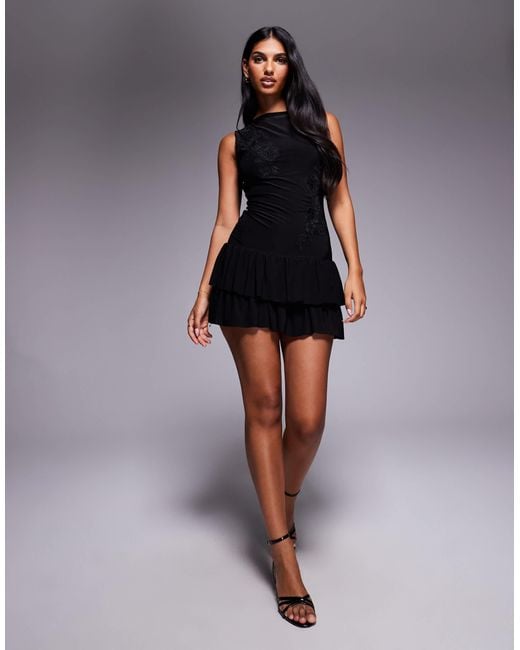 Fashionkilla Black Double-sculpted Slinky Slash Neck Low Back Ruffle Hem Flower Applique Mini Dress