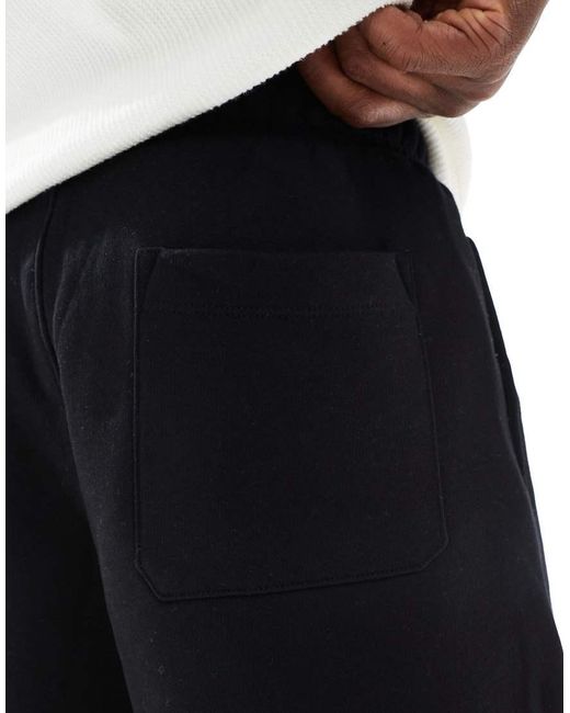 Pantalones Cortos Negros Básicos Extragrandes De Largo Medio De ASOS de hombre de color Black