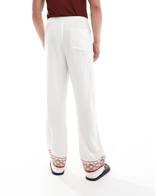 Pantalones s holgados con bordados en los bajos ASOS de hombre de color White