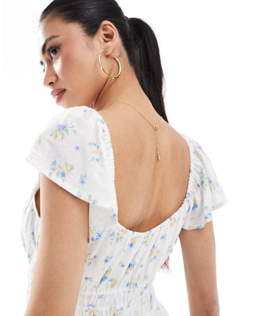 Vestido Midi De Manga Corta De Estilo Mesonera Con Estampado Floral Azul Y Abertura De Hollister de color White