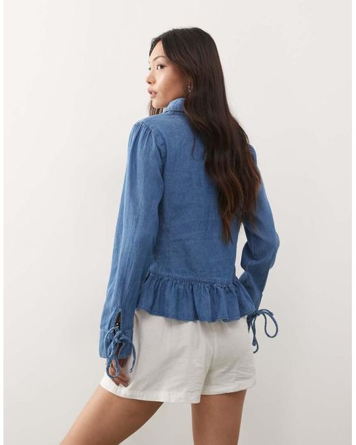 Reclaimed Vintage Blue Long Sleeve Denim Tie Front Top With Peplum Hem
