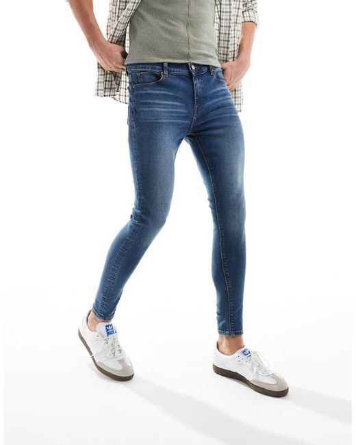 Vaqueros Elásticos De Corte Superpitillo Con Lavado Azul Medio De ASOS de hombre de color Blue