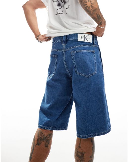 Pantaloncini di jeans larghi lavaggio medio di Calvin Klein in Blue da Uomo