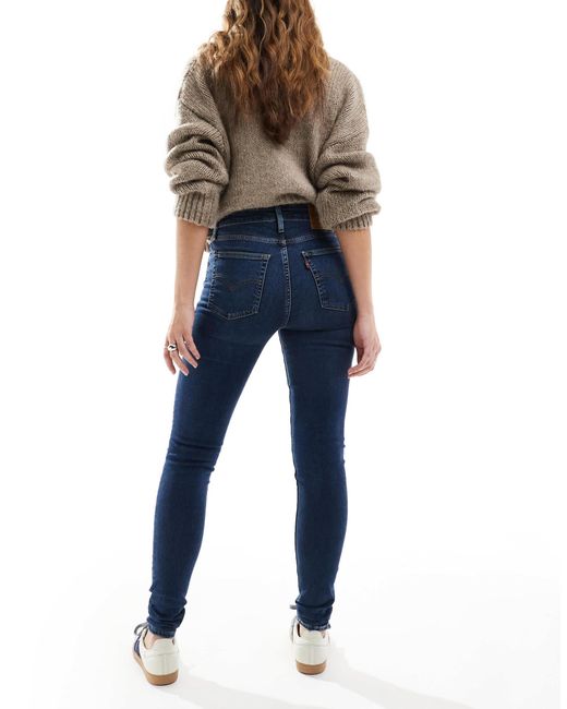721 - jean skinny à taille haute - délavage moyen Levi's en coloris Blue