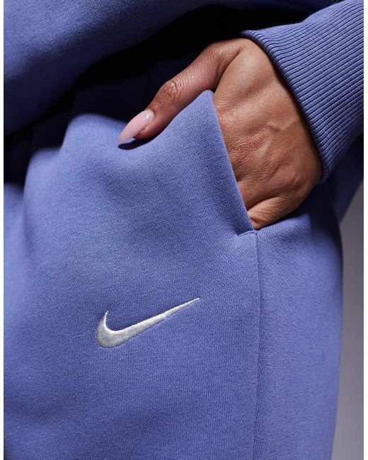 Joggers Azules Extragrandes De Talle Alto Con Bajos Ajustados Phoenix Fleece De Nike de color Blue