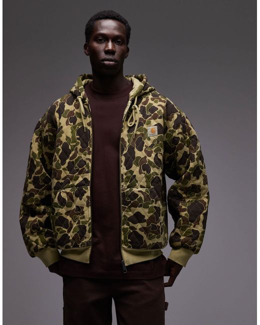 Carhartt – vista – gesteppte oversize-kapuzenjacke mit military-muster in Brown für Herren