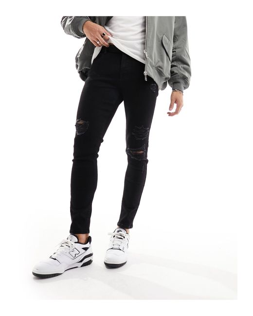 ASOS Black Spray On Jeans With Power Stretch And Heavy Rips for men