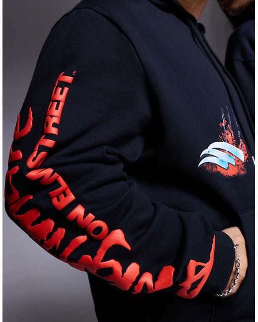 Felpa Oversize Nera Con Cappuccio E Stampa “Nightmare On Elm Street” di ASOS in Blue