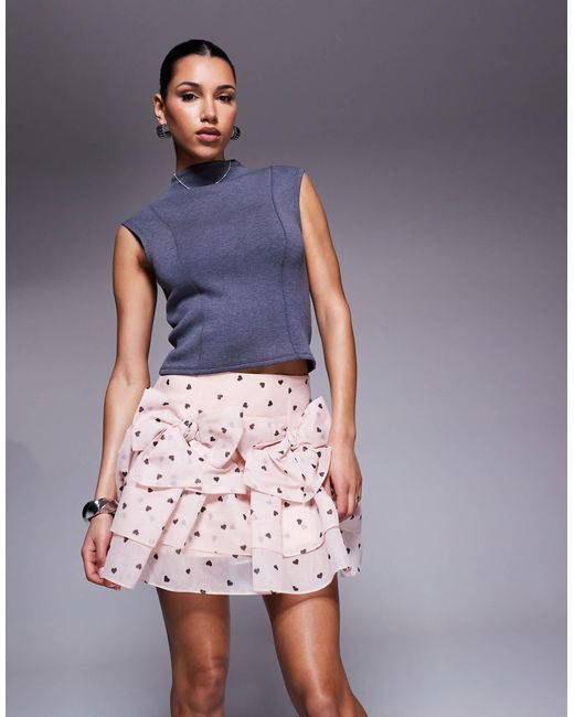 Mini-jupe à imprimé cœurs et nœuds devant ASOS en coloris Pink