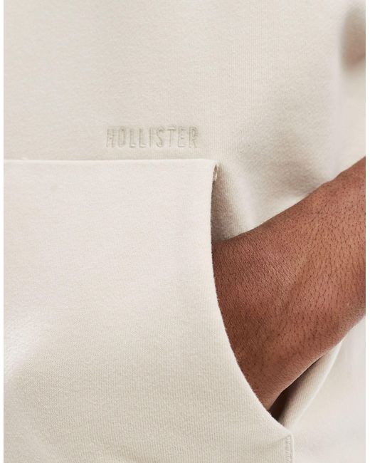 Sweat à capuche oversize en tissu éponge avec logo manuscrit et manches coupées - beige Hollister pour homme en coloris White