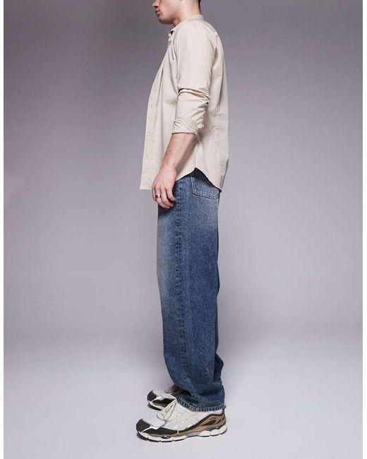 Vaqueros Holgados Con Lavado Azul Oscuro De ASOS de hombre de color Blue