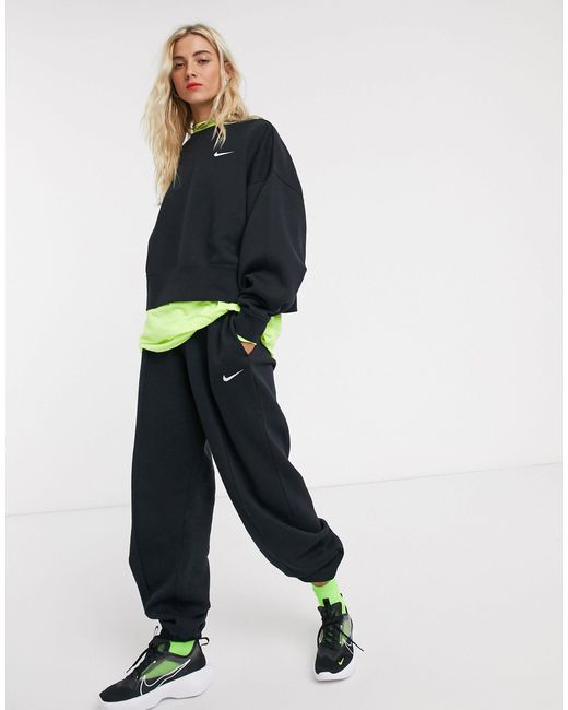 nike mini swoosh oversized yellow joggers