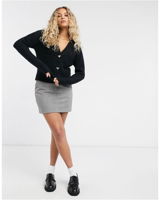 black cardigan with dinosaur buttons