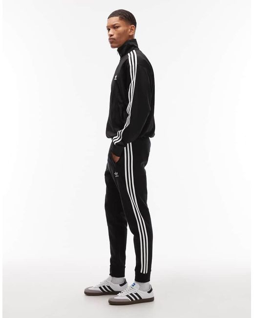 Adidas Originals Blue Three Stripe joggers for men