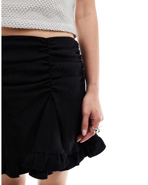 Weekday Black Suzi Mini Skirt With Ruched Detail And Frill Hem
