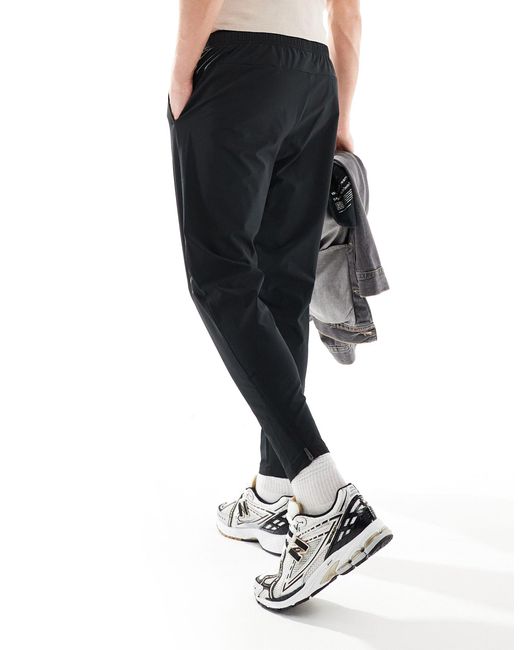 Tenacity - pantaloni elasticizzati neri di New Balance in Black da Uomo
