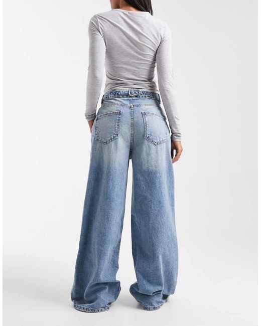 Vaqueros De Pernera Ancha Y Talle Alto Con Lavado Envejecido Tenue Y Detalle De Tira Ajustable De -Azul ASOS de color Blue