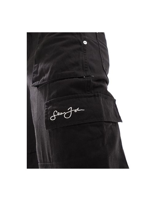Pantalon cargo ample à logo manuscrit et ourlet fendu devant Sean John pour homme en coloris Black