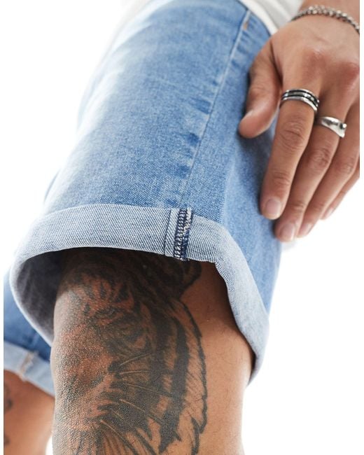Pantaloncini di jeans slim elasticizzati lunghezza normale lavaggio chiaro vintage di ASOS in Blue da Uomo