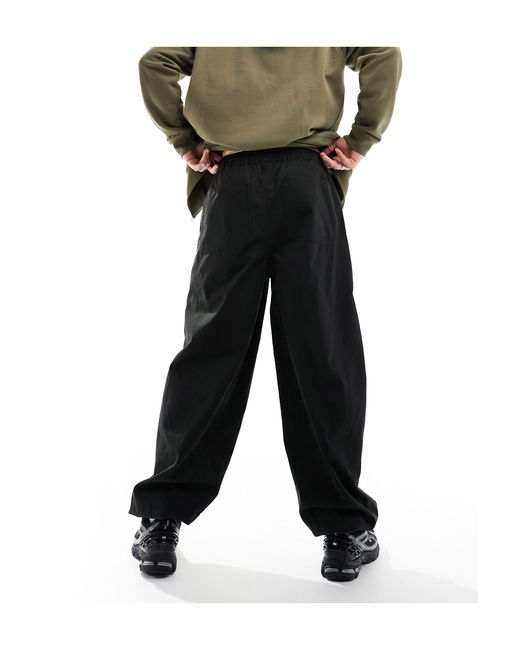 Pantalones cargo s sueltos con bolsillos delanteros con elástico ASOS de hombre de color Black