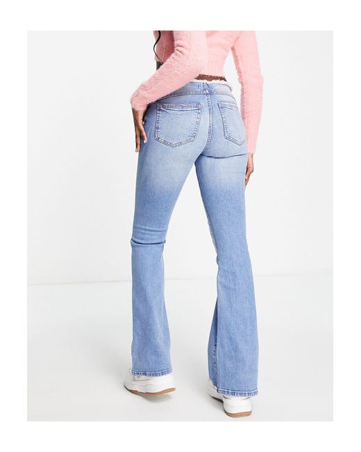 Miss Selfridge Flared Jeans Met Lage Taille, Onafgewerkte Zomen En Mid-wash  in het Blauw | Lyst NL