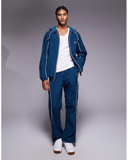 Liquor N Poker Blue Nylon Track Jacket With Logo And Piping Details for men