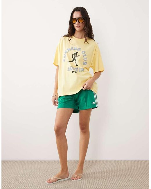 ASOS Yellow Short Sleeve Oversized T-shirt With Running Club Graphic
