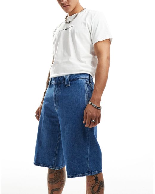 Pantaloncini di jeans larghi lavaggio medio di Calvin Klein in Blue da Uomo