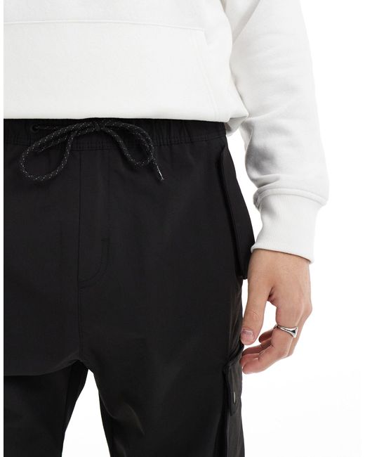 Pantalon cargo technique à poches Bershka pour homme en coloris Black