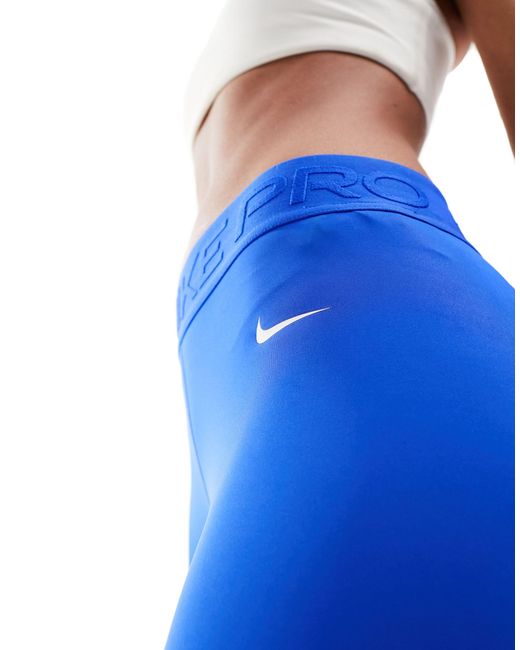 Buy Nike Blue Pro Mid-Rise 7/8 Graphic Training Leggings from Next Ireland