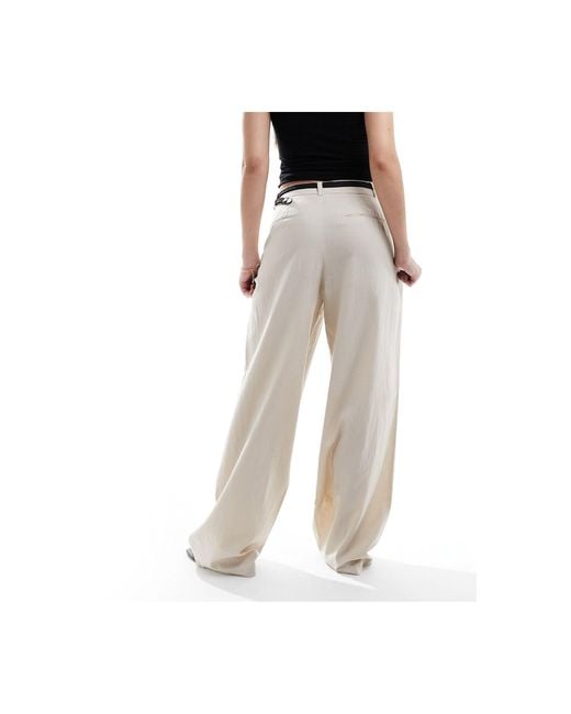 Pantaloni effetto lino colore con cintura di Stradivarius in White
