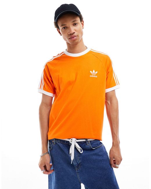 Adidas Originals – t-shirt mit drei streifen in Orange für Herren