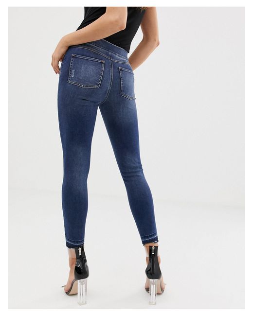 Spanx Denim Shape And Lift Distressed Skinny Jeans in Blue - Lyst