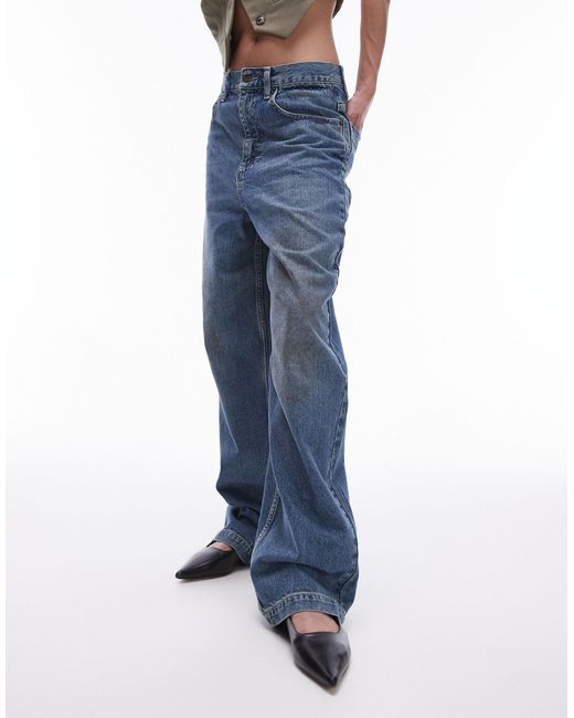 Jeans ampi medio a vita alta con macchie effetto fango di TOPSHOP in Blue