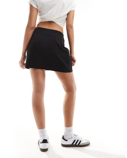 Mini-jupe ajustée à taille haute ASOS en coloris Black