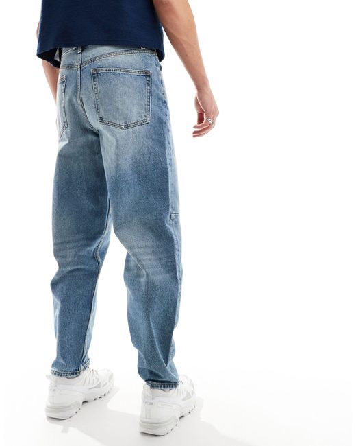 Jeans ampi lavaggio chiaro con baffature di ASOS in Blue da Uomo