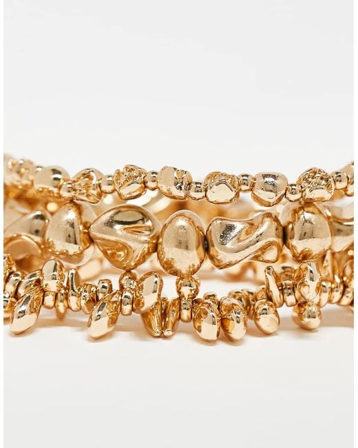 Confezione Da 3 Bracciali Rigidi Dorati Elasticizzati A Forma Di Coralli di Accessorize in Metallic
