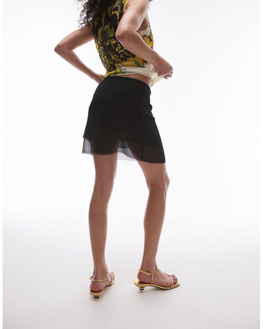 Mini-jupe transparente à taille basse TOPSHOP en coloris Black