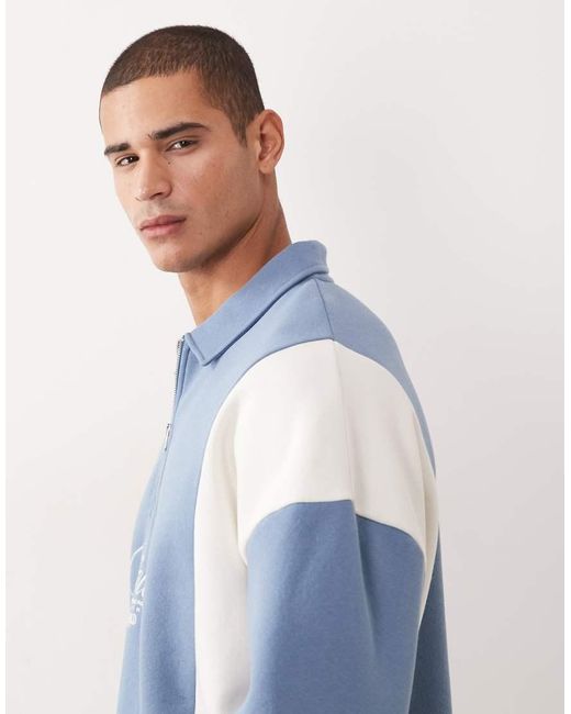 ASOS Blue Relaxed Quarter Zip With Cut & Sew Panels And Embroidered Print for men