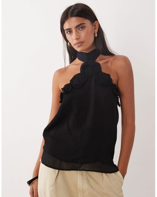 Top dos nu à rosette Mango en coloris Black