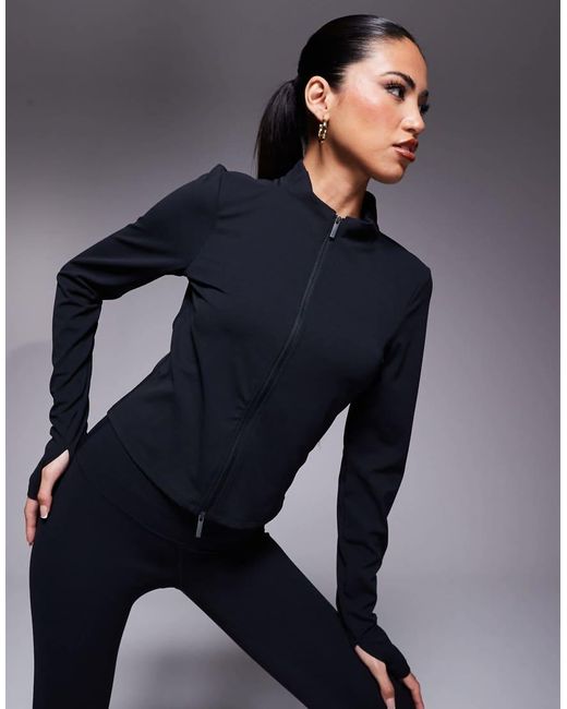 Top De Manga Larga Con Cremallera De Tejido Suave Dri-Fit Zenvy De Nike de color Blue
